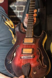 Garrett Rosen models one of his custom handmade guitars